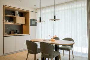 a dining room with a table and chairs at Amaris Suites Rabland, Südtirol in Rablà