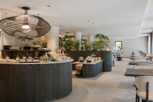 a dining room with tables and chairs at Amaris Suites Rabland, Südtirol in Rablà