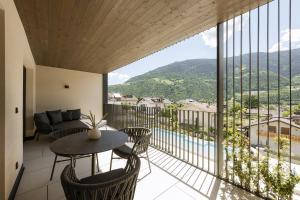 a balcony with a table and chairs and a view at Amaris Suites Rabland, Südtirol in Rablà +89 photos