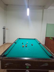a pool table with balls on it in a room at T&T Homestay in Kuta Lombok