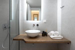 a bathroom with a bowl sink and a shower at Pomelo Parga Cozy Studios in Parga +23 photos