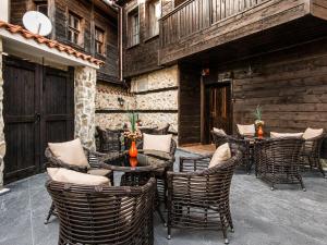 a patio with chairs and tables and a building at Effect Boutique Villa Azzura - Adults Only SELF CHECK-IN in Nesebar