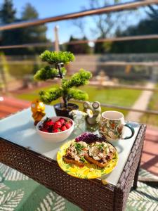 a table with a plate of food and a cup of coffee at Promenada in Węgierska Górka