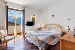 a bedroom with a bed and a large window at Colico Lake e Relax in Colico
