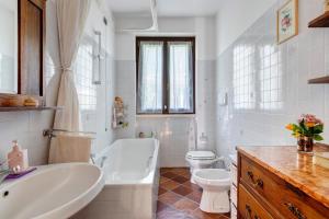 a white bathroom with a tub and a toilet and a sink at Colico Lake e Relax in Colico +26 photos