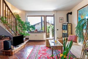 a living room with a couch and a tv at Colico Lake e Relax in Colico