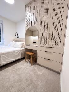 a bedroom with a bed and a cupboard at Mavrin Home Zagreb, free parking, 3,8km from Old Town, Breakfast in Zagreb