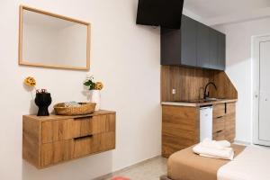 a kitchen with a sink and a mirror on the wall at Lecini Studios with Pool, by ZanteWize in Laganas