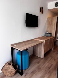 a desk with a television on a wall at Студия 310 и 312 на първа линия in Chernomorets