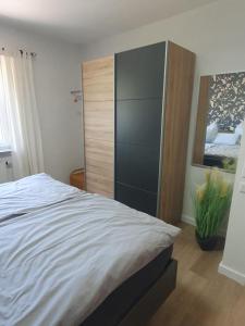 a bedroom with a large bed and a cabinet at Ferienwohnung Dreiländereck Gronau in Spechtholzhock