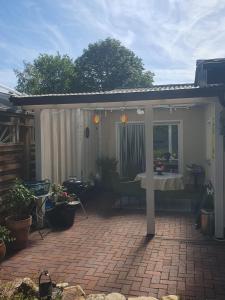 a patio with a table on a brick patio at Ferienwohnung Dreiländereck Gronau in Spechtholzhock