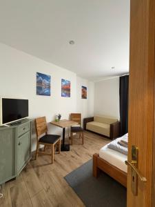 a hotel room with a bed and a living room at Apartmány BRETZ in Vrbov
