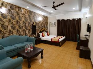 a room with a bed and a couch and a table at Hotel Maurya Heritage In Karol Bagh in New Delhi