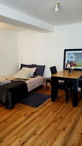 a bedroom with a bed and a desk and a table at Studio Confort in Château-Chinon