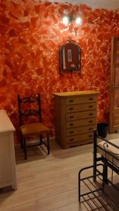 a room with a dresser and a chair and a mirror at affittacamere de al vecchio scalo in Isola del Cantone