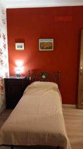 a red room with a bed and a red wall at affittacamere de al vecchio scalo in Isola del Cantone +18 photos