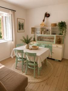 a kitchen with a table and chairs in a room at House by the River in Orja Luka +5 photos