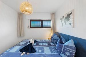 a bedroom with a blue bed and a blue couch at Schwarzwald Residenz Hirschen in Schönwald +24 photos