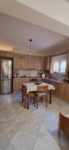a large kitchen with a table and chairs in it at Simos in Vrontádos