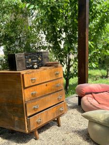 a wooden dresser with a radio on top of it at GuestHouse "Shtëpia ime" in Përmet