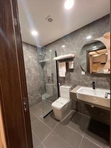 a bathroom with a toilet and a sink and a shower at Teral Hotel by Fleur de Lys in Dakar +8 photos