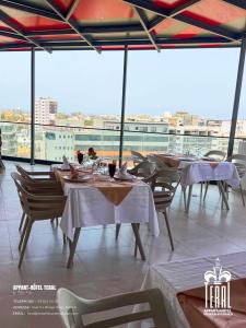 a restaurant with tables and chairs on a roof at Teral Hotel by Fleur de Lys in Dakar