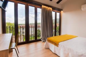 a bedroom with a bed and a balcony at Hotel Casa Juan in Ayegui