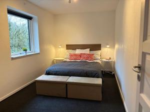 a bedroom with a bed and a window at Dream house in Glesborg