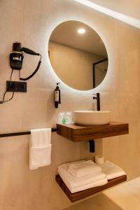 a bathroom with a sink and a mirror at Hotel Casa Juan in Ayegui +15 photos