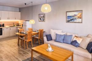 a living room with a couch and a table at Poolside condo in Golden Sands in Varna City