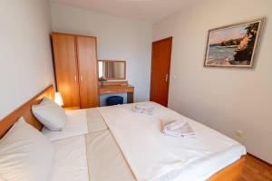 a bedroom with a white bed in a room at Poolside condo in Golden Sands in Varna City +20 photos