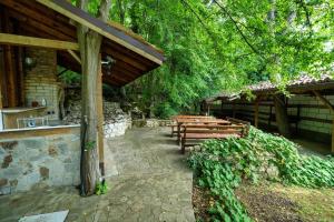 a group of wooden benches sitting under a building at Poolside condo in Golden Sands in Varna City