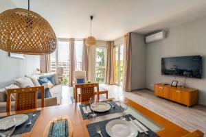 a living room with a table and a living room with a couch at Poolside condo in Golden Sands in Varna City
