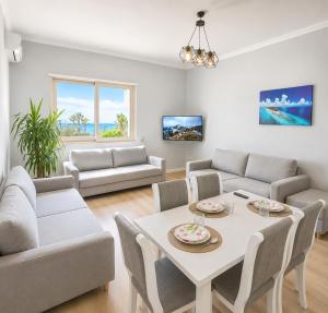a living room with a white table and chairs at Flors Apartments in Durrës