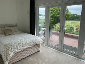 a bedroom with a bed and sliding glass doors at Solihull Twin Room Wi-fi, TV in Solihull