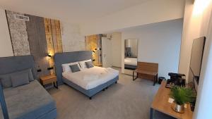 a bedroom with a bed and a living room with a couch at MOUNTAIN SUITE Hotel Apartment in Tirano