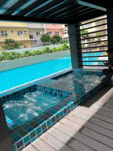 a man sitting next to a swimming pool at Gabbys Place in Bacolod