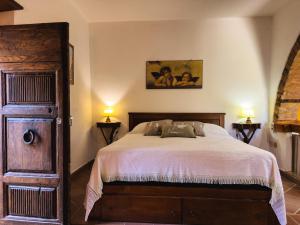 a bedroom with a bed and two lamps on two tables at Il giardino di Nara in San Gimignano