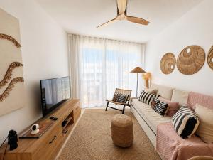 a living room with a couch and a flat screen tv at Ocean View in Puerto de Santiago