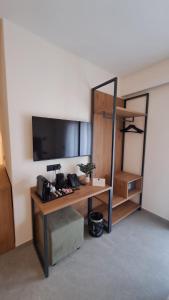a room with a desk with a flat screen tv at MOUNTAIN SUITE Hotel Apartment in Tirano +35 photos
