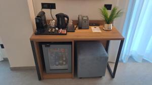 a wooden table with a desk with a television under it at MOUNTAIN SUITE Hotel Apartment in Tirano