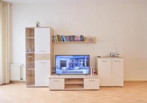a living room with a flat screen tv on a table at Haus Düne, Ferienwohnung 21 in Cuxhaven