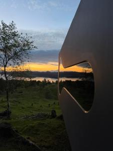 a view of a sunset from the side of a building at Birdbox Forland in Stord +6 photos