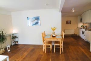 a kitchen and dining room with a table and chairs at Apple Tree Garden House in Örebro