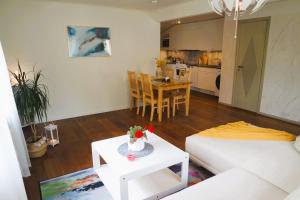 a living room with a white couch and a table at Apple Tree Garden House in Örebro