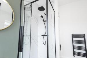 a shower in a bathroom with a mirror at Spacious Beach House Near Promenade & Beach Sleeps 6 in Newbiggin-by-the-Sea +33 photos