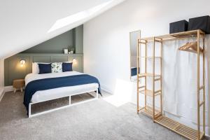 a bedroom with a bed and a ladder at Spacious Beach House Near Promenade & Beach Sleeps 6 in Newbiggin-by-the-Sea