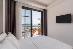 a hotel room with a bed and a large window at AsiaHOTEL in Bodrum City
