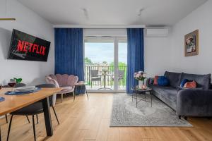 a living room with a couch and a table at Lumina I Premium 3-room Apartments with Parking I Balcony I Manufaktura in Łódź