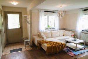 a living room with a white couch and a table at Apple Tree Garden House in Örebro